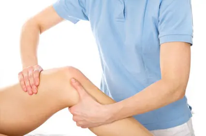 Physiotherapist performing hands-on treatment of a patient's knee